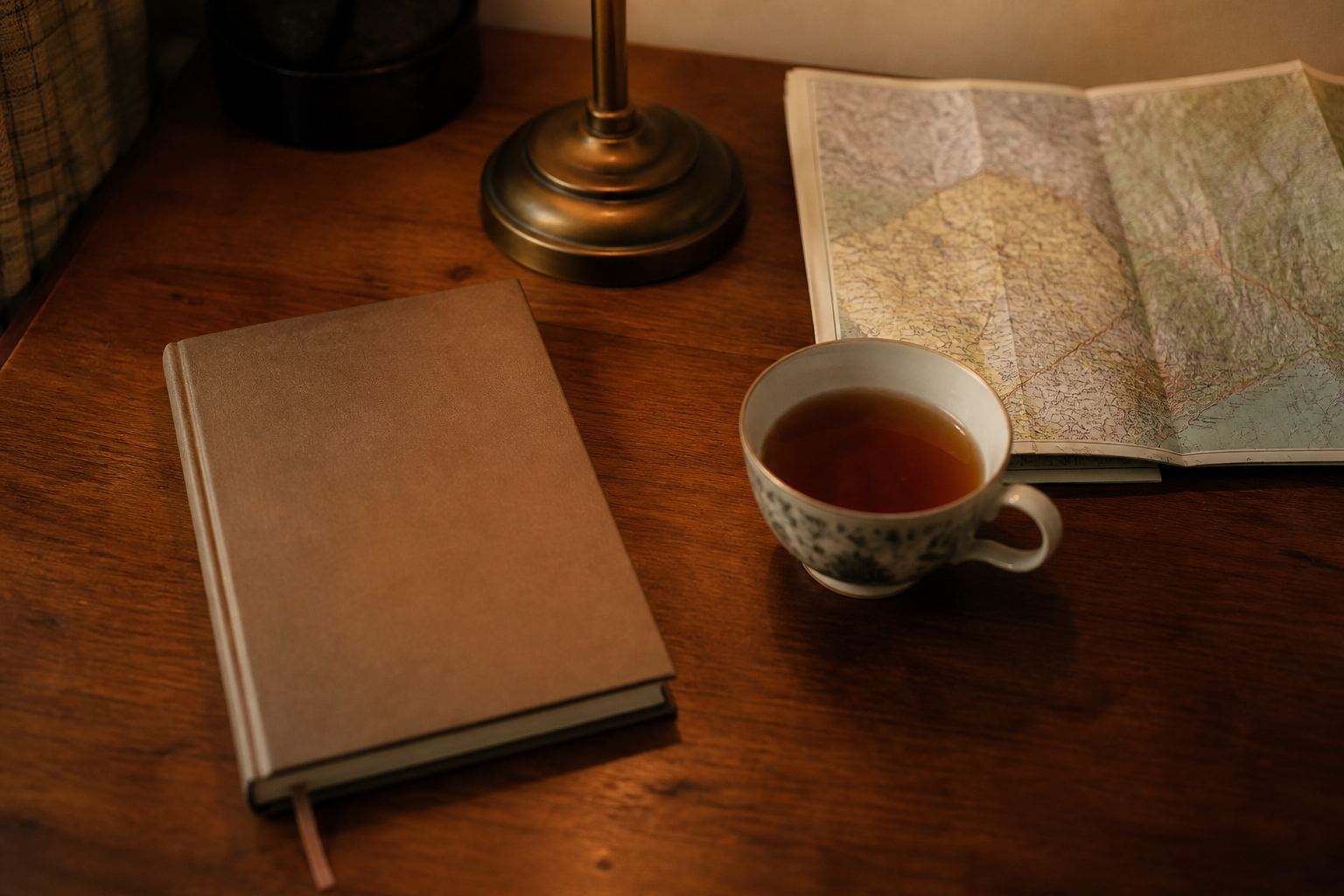 A closed notebook on a wooden desk.